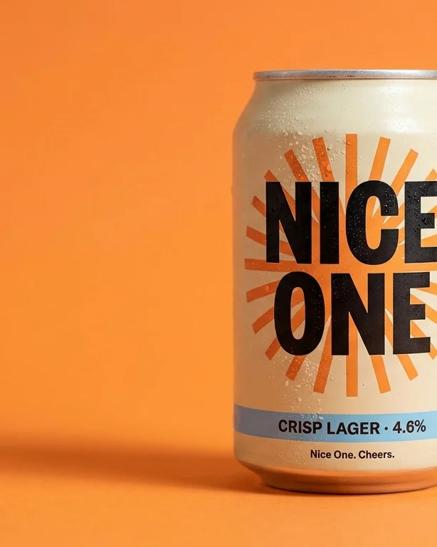 The Nice One can against a flat tangerine studio backdrop